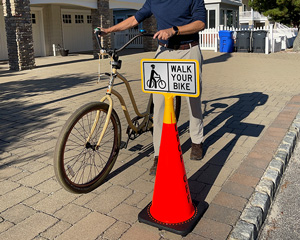 Walk you bike cone sign