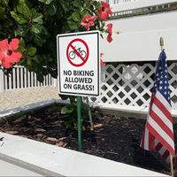 No Bicycle Riding on Grass Sign
